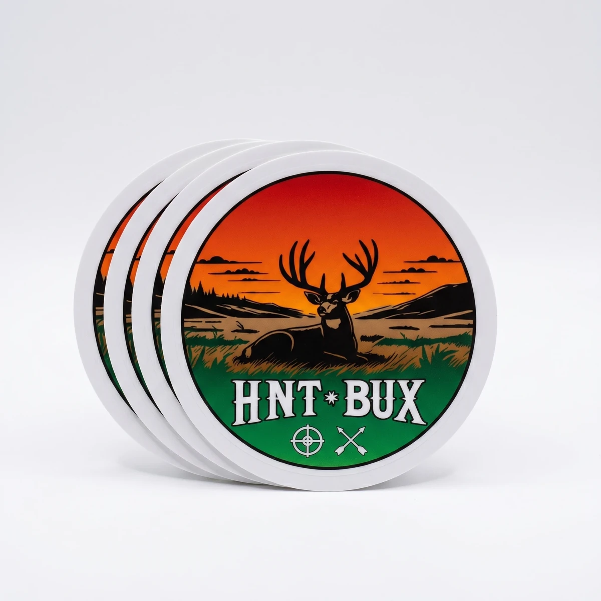 Stack of round HNT BUX vinyl stickers with sunset and deer artwork